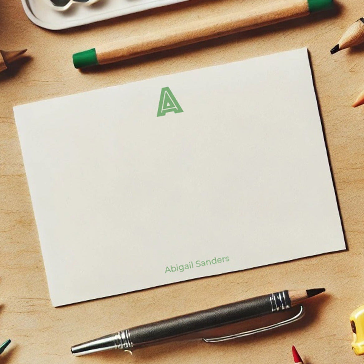 Colorful personalised children’s stationery on a wooden surface.